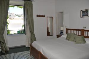 a bedroom with a large bed and a window at Hotel Parsifal - Antico Convento del 1288 in Ravello