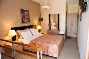 Ένα ή περισσότερα κρεβάτια σε δωμάτιο στο Palmira Apartments