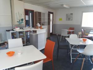 a dining room with white tables and chairs at Hotel Motel Limoux in Limoux +13 photos