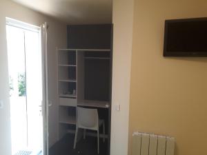 a room with a desk and a chair and a window at Hotel Motel Limoux in Limoux
