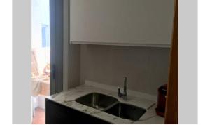 a kitchen with a sink and a counter top at Petit con piscina in Pontevedra +9 photos