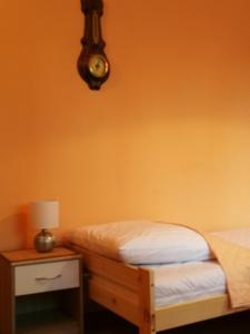 a bedroom with a bed and a table with a lamp at Noclegi u Mai in Olsztyn