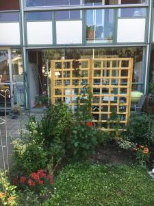 a garden in front of a building with windows at Farsta Bed and Breakfast in Stockholm