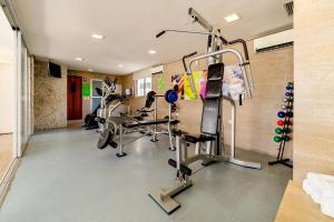 a gym with treadmills and machines in a room at Kastel Manibu Recife - Boa Viagem in Recife