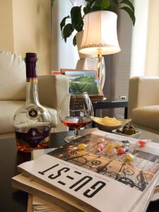 a bottle of wine and a book on a table at Hotel Senator in Gorgonzola