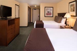 a hotel room with two beds and a flat screen tv at Red Lion Hotel Yakima Center in Yakima