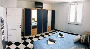 a room with a blue bed and a mirror at Mundial Apartments in Njivice