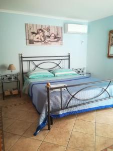 a bedroom with a bed with a metal frame at La Casina Nel Borgo in Viterbo