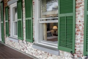 a window with green shutters on a building at The Marshall House, Historic Inns of Savannah Collection in Savannah