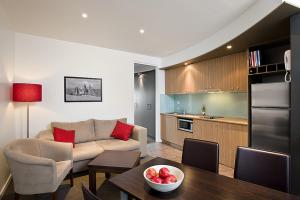 a living room and kitchen with a couch and a table at The Waves Apartments in Cowes