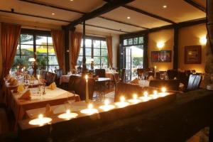 a restaurant with tables and candles in a room at Lahnromantik in Nassau
