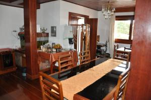 a kitchen and dining room with a table and chairs at Pousada Monte Carlo in São Joaquim