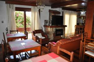 a living room with a couch and a fireplace at Pousada Monte Carlo in São Joaquim