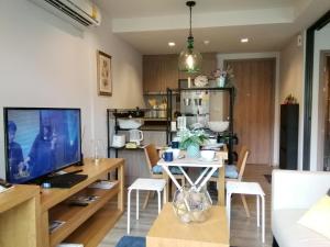 a kitchen and living room with a table and a television at Rain​ Cha​ Am​ -​ Hua​ ​Hin​ by​ Good​ Luck​ Home in Cha Am