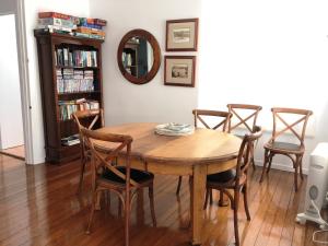 
a dining room table and chairs in a room at Bluewater House in Narooma
