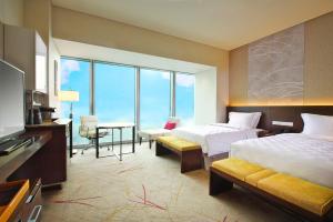 a hotel room with two beds and a television at Osaka Marriott Miyako Hotel in Osaka