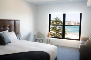 a hotel room with a view of the ocean at Bondi 38 Serviced Apartments in Sydney