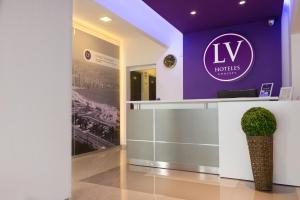a lobby of a hotel with a sign on the wall at LV Hoteles in Viña del Mar