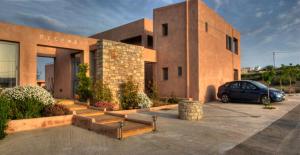 a building with a car parked in a parking lot at Petradi in Livadi