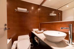 a bathroom with a white sink and a toilet at Matsumoto Marunouchi Hotel in Matsumoto