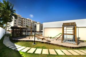 a park with a playground with a swing at Apartamento Ilhéus - Vog Sul in Ilhéus
