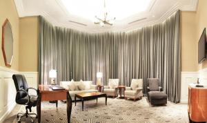 a living room with a couch and chairs at Grand Hotel Preanger in Bandung