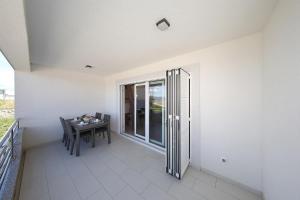 a balcony with a table and a window at Apartment Lana in Pašman