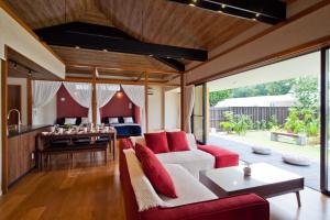 a living room with a couch and a table at Bougain Terrace Resort Thi-chi House in Nago