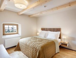 a bedroom with a large bed and a window at Hotel Kleis in Cvikov