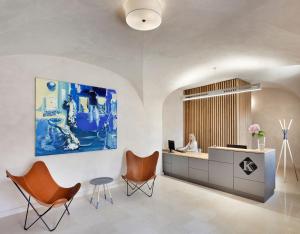 a lobby with a woman sitting at a desk at Hotel Kleis in Cvikov