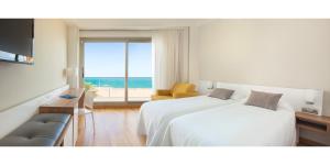 a hotel room with two beds and a view of the ocean at RH Bayren Hotel & Spa 4* Sup in Gandía