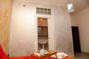 a living room with a red couch and a table at Viale Italia 41: I migliori anni in Sassari +18 photos