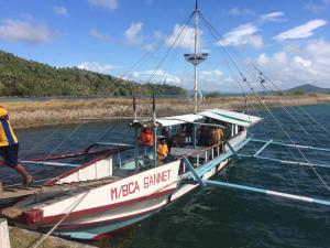 a boat is docked at a dock in the water at Costa Aguada Island Resort, Guimaras in Guimaras