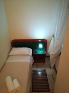 A bed or beds in a room at Albergo Ristorante Bar Pizzeria La Lanterna