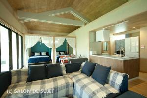 a living room with two couches and a kitchen at Bougain Terrace Resort Ta-chi House in Nago