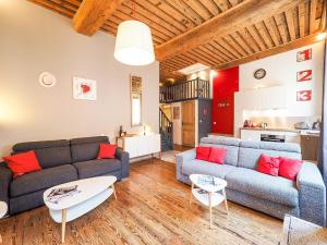 a living room with two couches and a kitchen at La Nuit Saint Georges in Lyon