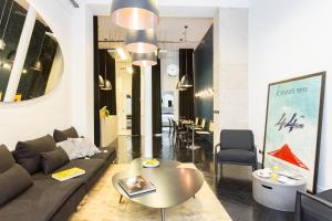 a living room with a couch and a table and chairs at Loft Greneta in Paris