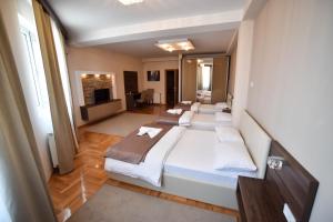 Llit o llits en una habitació de Garni Uni Elita Lux Hotel