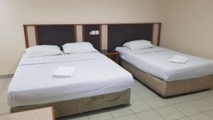Ένα ή περισσότερα κρεβάτια σε δωμάτιο στο Prime Hotel
