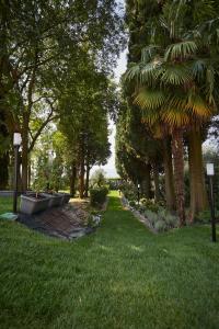 a park with trees and grass and a pathway at Appartamenti Villa Andrea in Garda