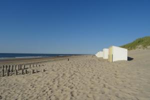 una playa de arena con un edificio blanco en Wondergem, en Oostkapelle