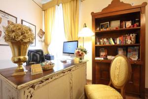 a room with a desk with a computer and a chair at B&B Relais Il Campanile in Florence