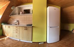 a kitchen with a white refrigerator in a room at Chalupa Podlesí in Podlesí