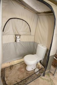 a toilet sitting inside of a tent at Old Mac Daddy in Botrivier