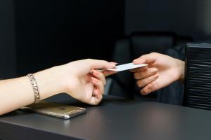 two people holding a piece of paper in their hands at Hotel Antonio in Uzhhorod