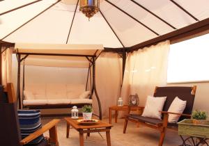 a living room with a bed in a tent at Isolabella in Mazara del Vallo