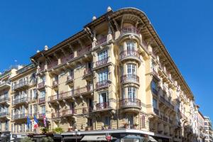 a yellow building with balconies on the side of it at Best Western Plus Hôtel Massena Nice in Nice