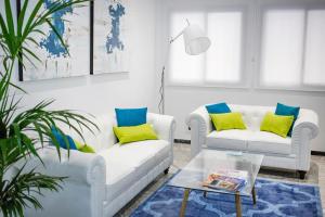 
a living room filled with furniture and a window at Soho Bahía Málaga in Málaga
