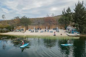 a group of people on paddle boards in the water at Old Mac Daddy in Botrivier