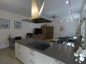 a kitchen with a counter top and a living room at Ferienwohnung auf dem Sturmhof in Grefrath